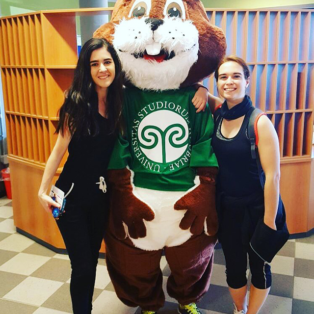Two students and one of the Uninsubria squirrel Mascots