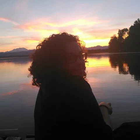 Student in front of a lake