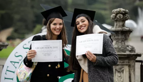 Two students with their Graduation day certificate in hand