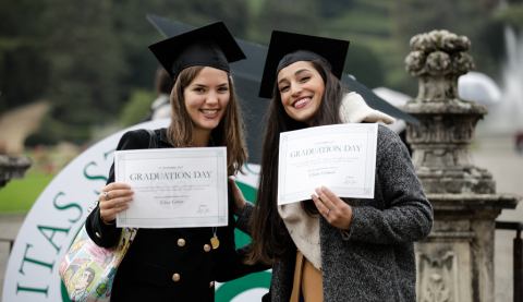 Two students with their Graduation day certificate in hand