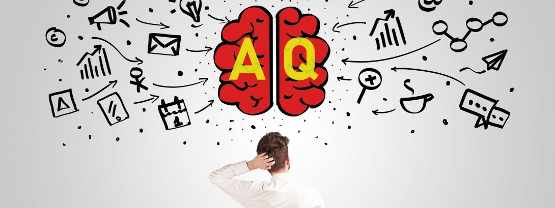 boy scratching his head while looking at a drawing of a red brain surrounded by symbols and the letters AQ superimposed on it