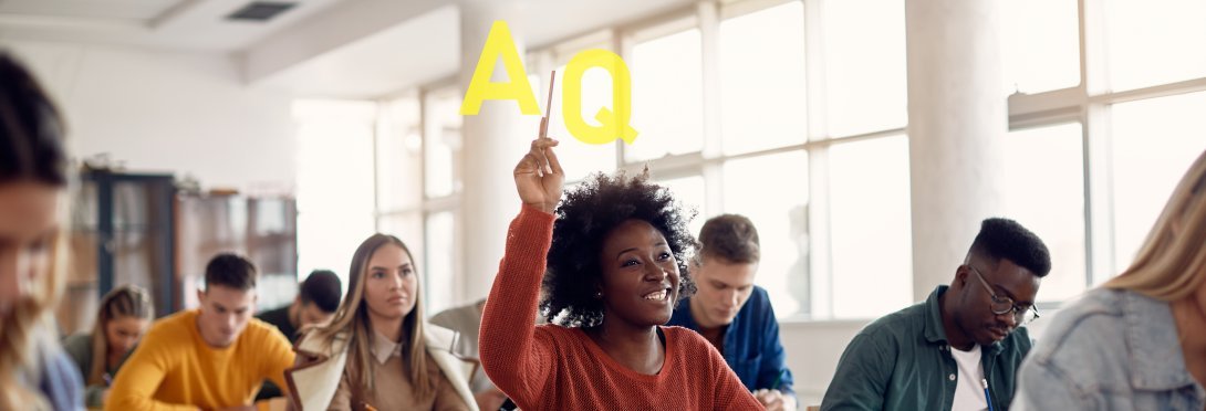 student in class with hand raised