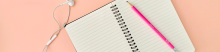 a notebook open on a pink background