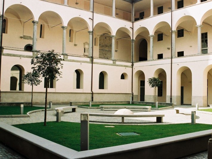 Cloister with arches, lawn, benches