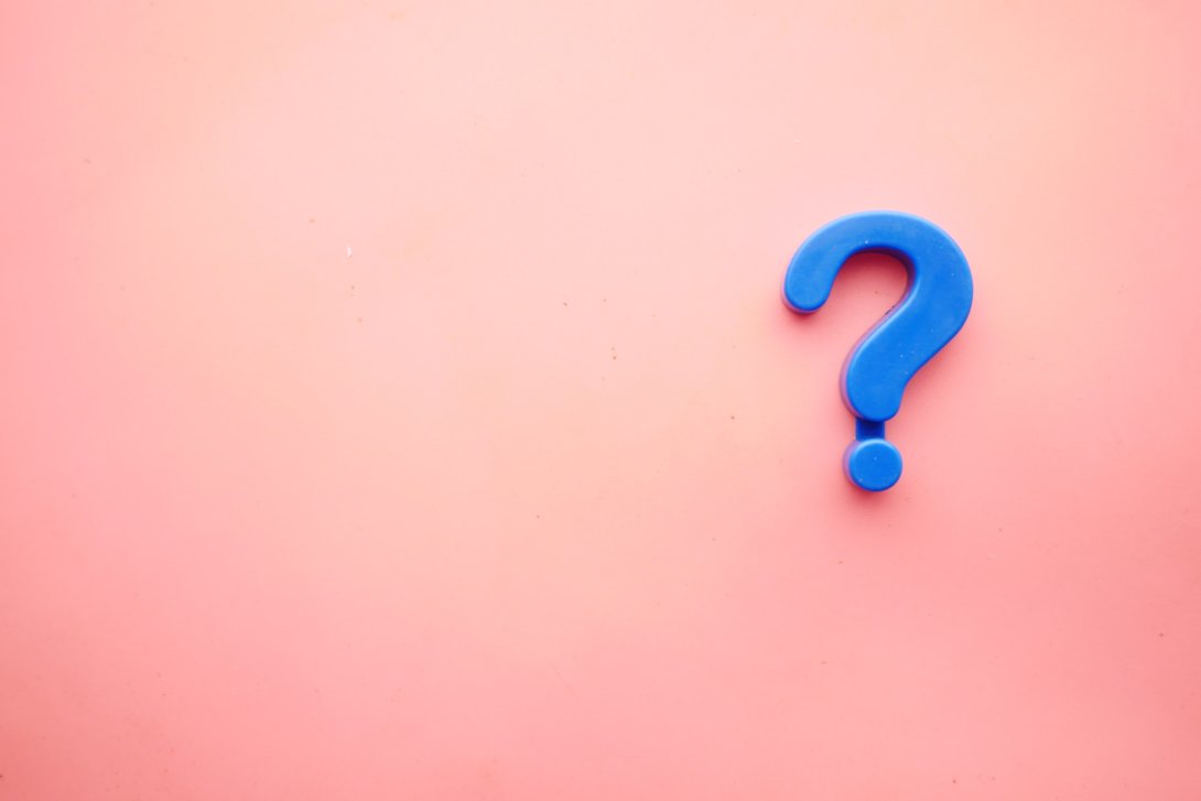 image of a blue question mark on a pink background